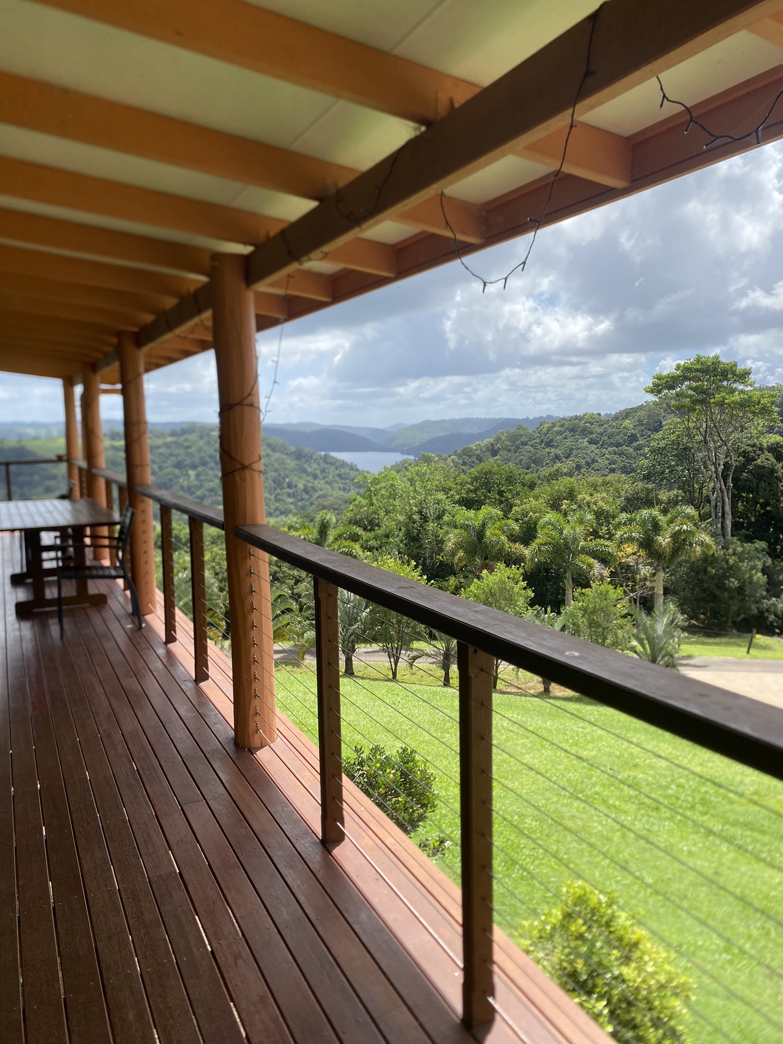 Group of women holding hands in a circle during a nature retreat