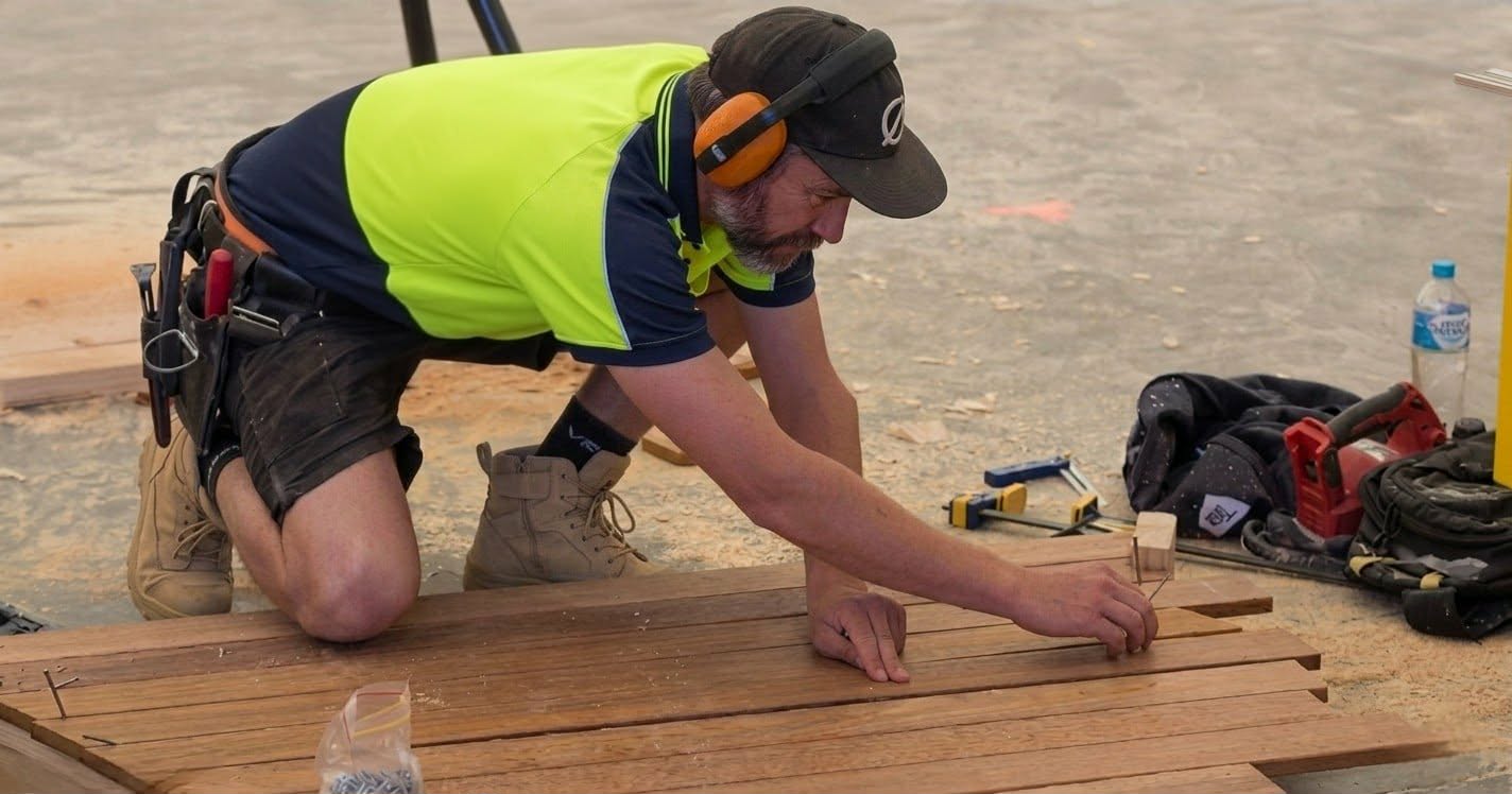 Aussie tradesperson experiencing lower back pain on a job site