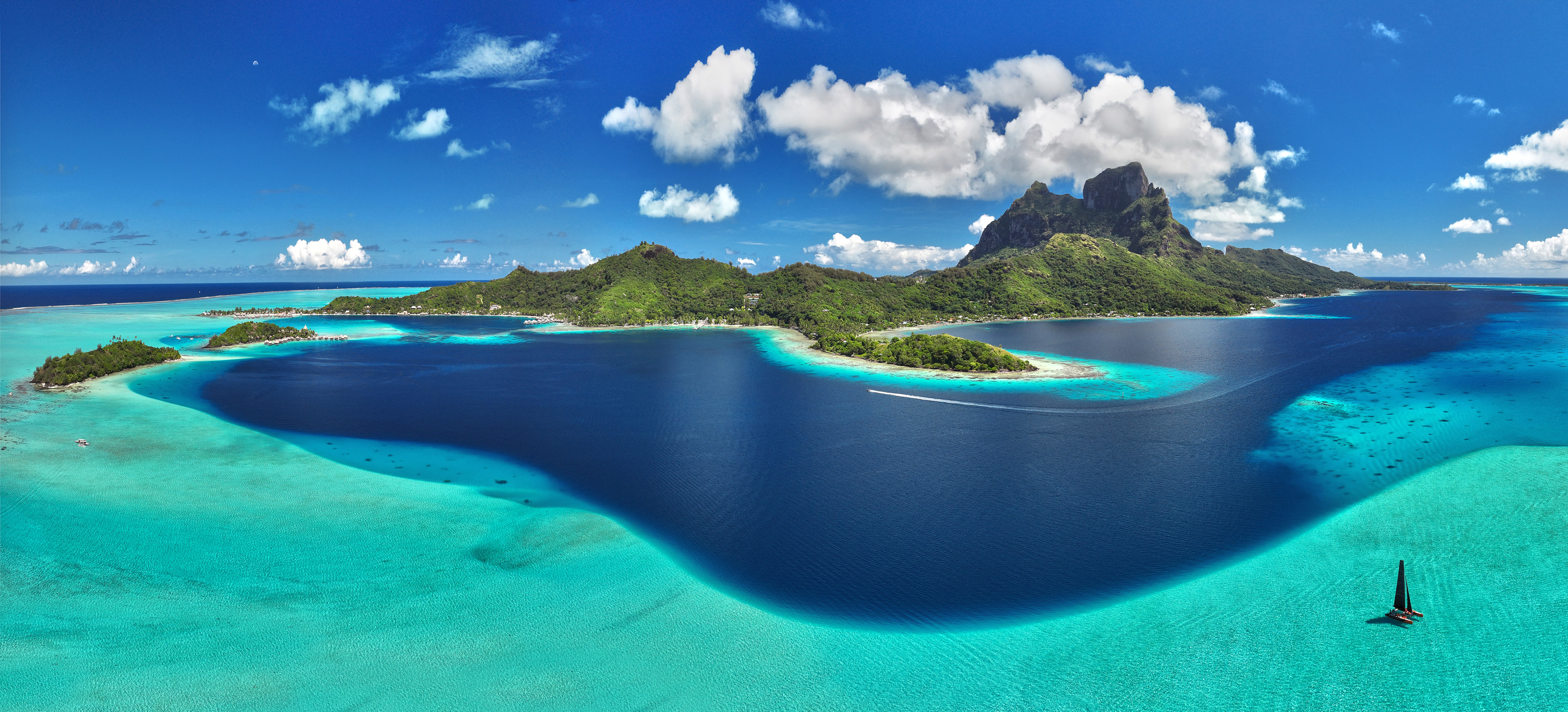 A beautifully appointed, spacious cabin interior on an Aranui cruise ship featuring a large window.